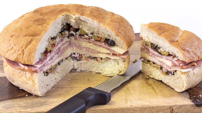 Muffuletta sandwich cut on board