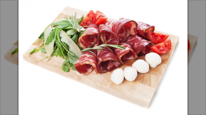 Sliced capicola on cutting board