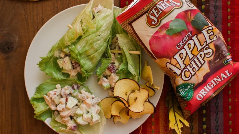 chicken salad wrap on plate with bag of chips