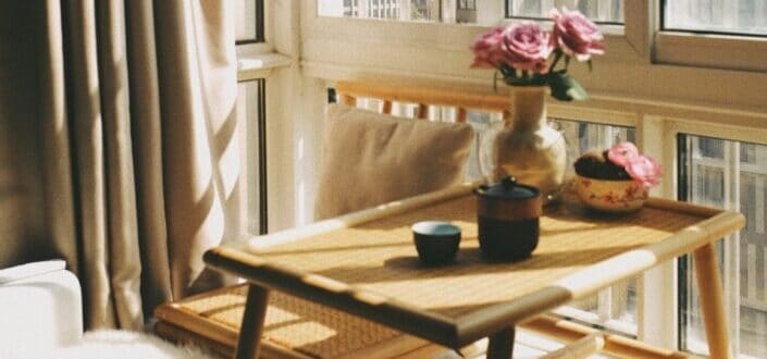 Pink flowers in top of brown table.