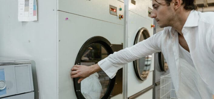 Man holding the washing machine door