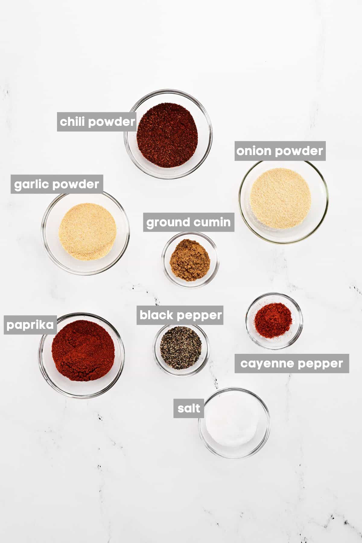 Labeled seasonings in bowls.