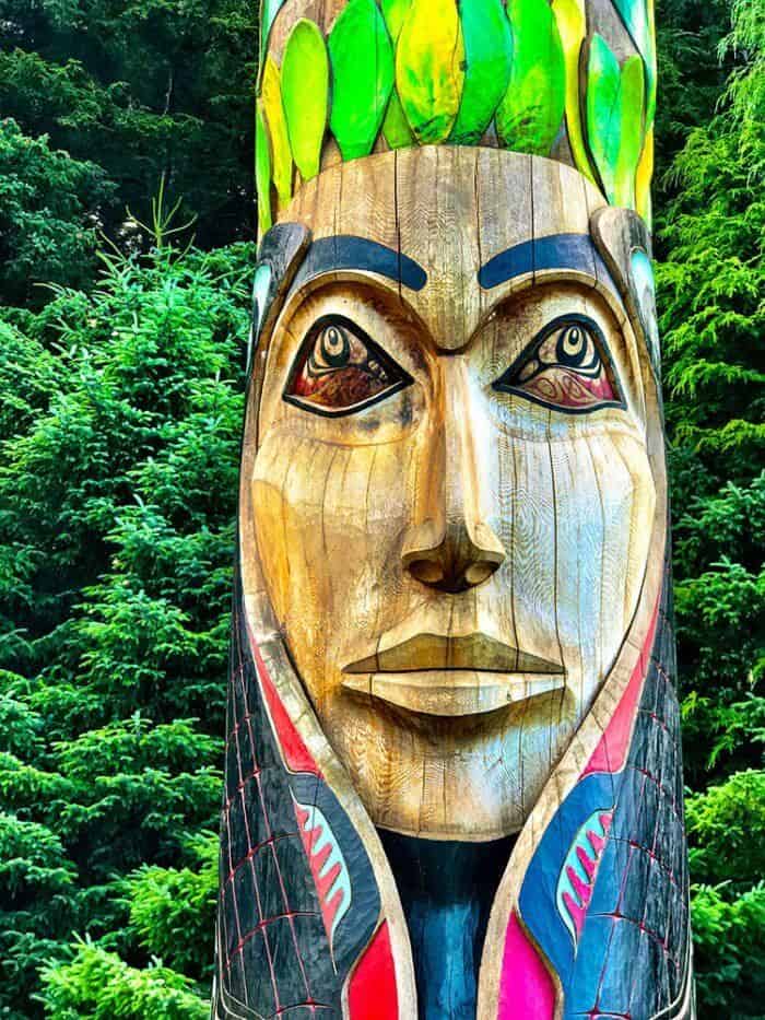 large totem poles in the woods inside Sitka National Park