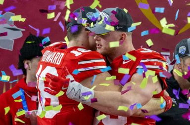 Ohio State graduate quarterback Will Howard (18) and senior defensive end Jack Sawyer (33) embrace after the College Football Playoff semifinal against Texas. The Buckeyes defeated the Longhorns 28-14 in the Cotton Bowl Classic. Credit: Sandra Fu | Photo Editor