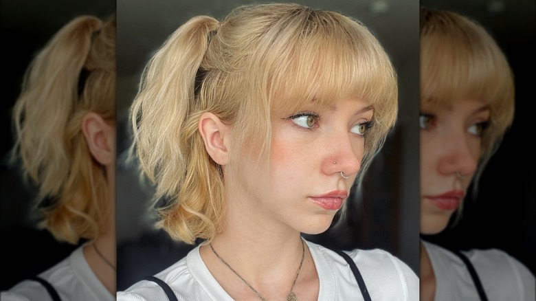 woman with partial pigtails and half-moon bangs