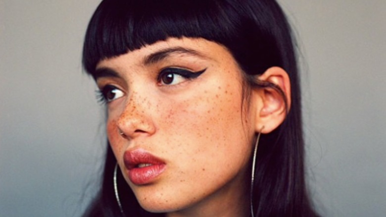 woman posing with straight bang haircut