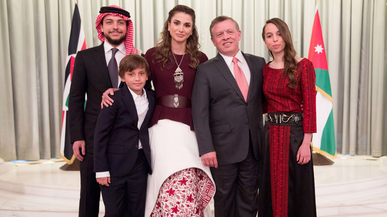 Queen Rania standing with her family