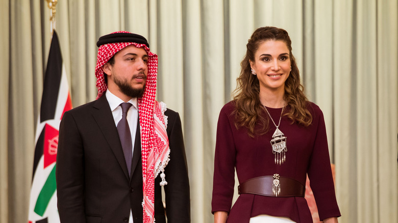 Prince Hussein standing with Queen Rania, posing