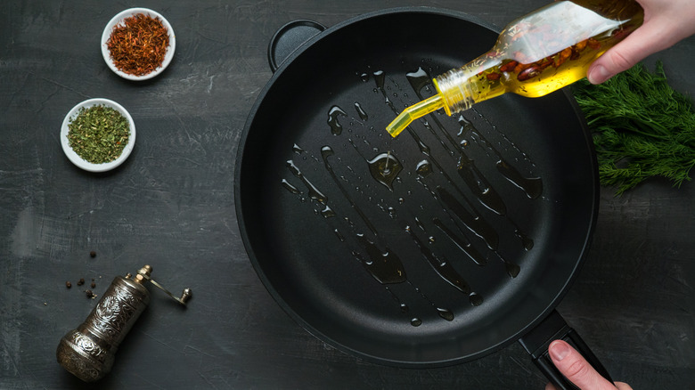 Pouring oil into pan