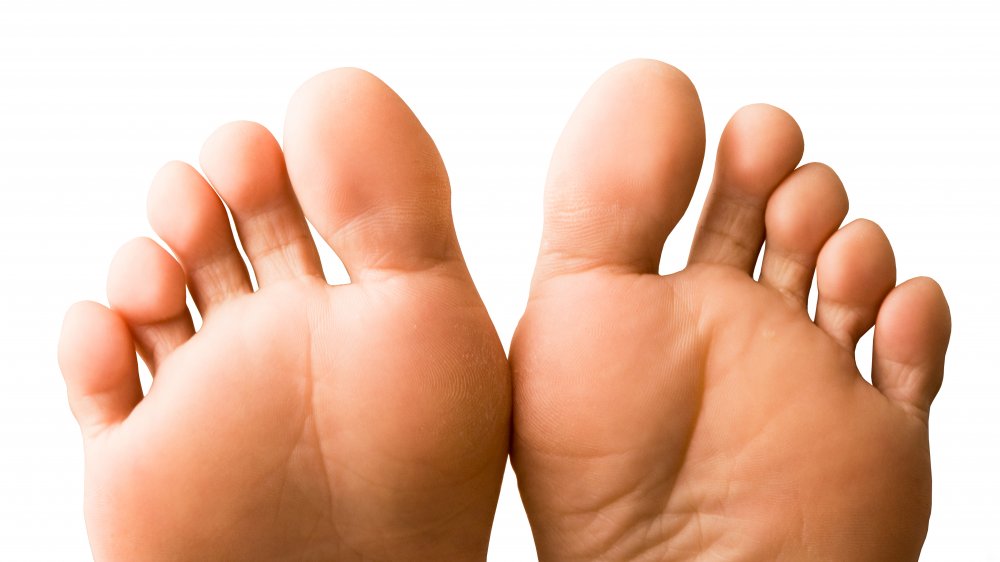 The bottom of a woman's feet, white background