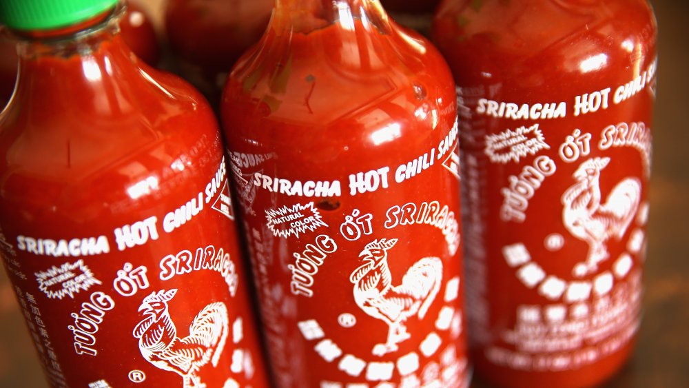 Several bottles of sriracha sauce