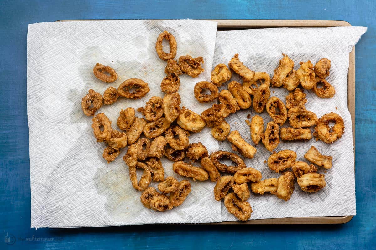 Fried calamari on top of paper towel soaking up the oil