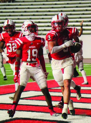 Bakersfield College football players run into endzone to score touchdown during September 3 game