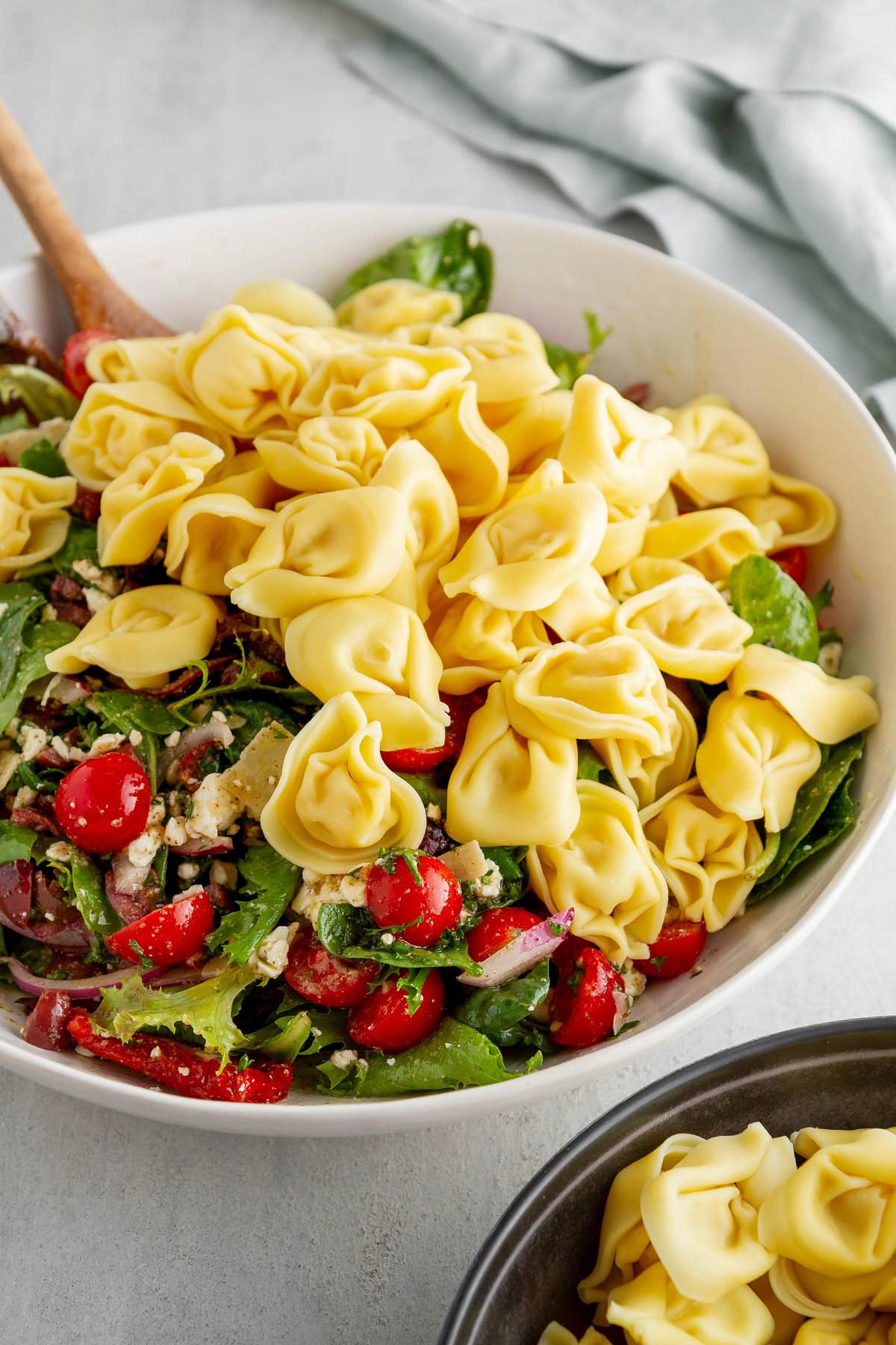 Salad and tortellini noodles in a large salad bowl