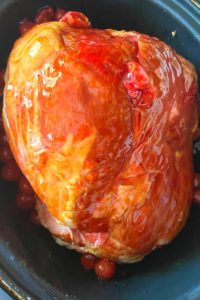 Crock Pot Cherry Ham is double the cherry flavor with an easy cherry glaze made of Cherry Pie Filling, Cherry Cola and brown sugar.  Don't forget to turn on the Crock Pot, and in 6 short hours, you'll have a sweet ham fit for any holiday.