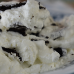 Grandma's Famous Chocolate Wafer Icebox Cake has layers of whipped cream and chocolate wafer cookies to form an easy icebox cake.