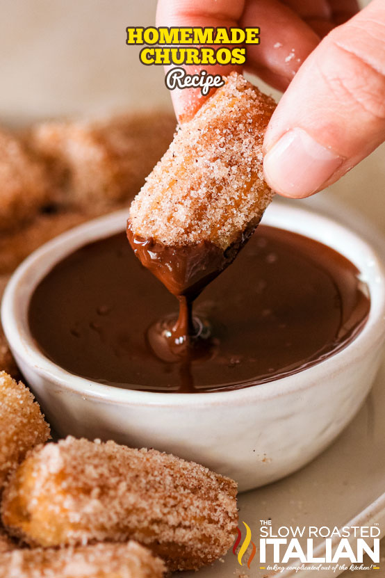 dipping mexican fried donut into chocolate sauce