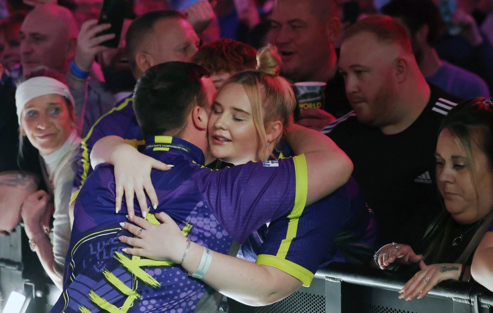 Luke Littler hugs his girlfriend Eloise Milburn ahead of the dart final