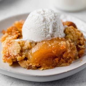 apple dump cake with a scoop of vanilla ice cream