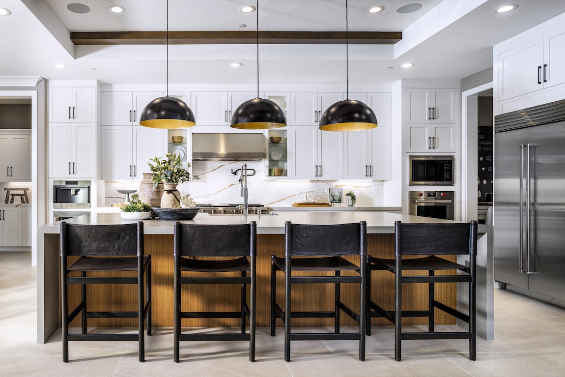 new industrial kitchen design featuring oversized pendant lighting and dark bar stools