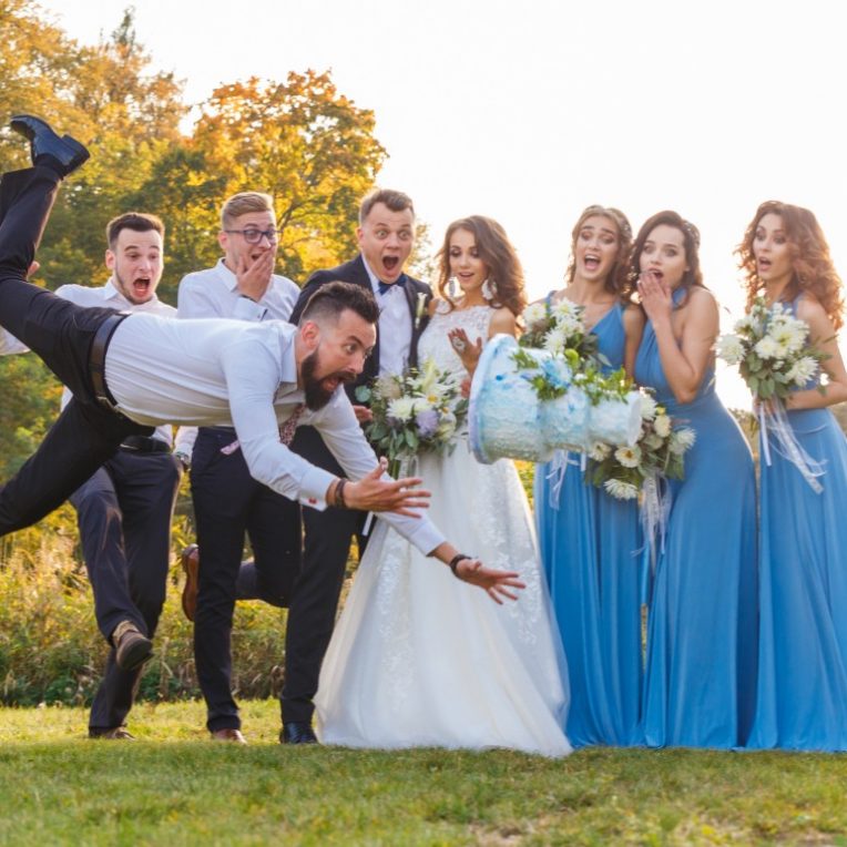 Funny picture of the bridal party in grassy sunset