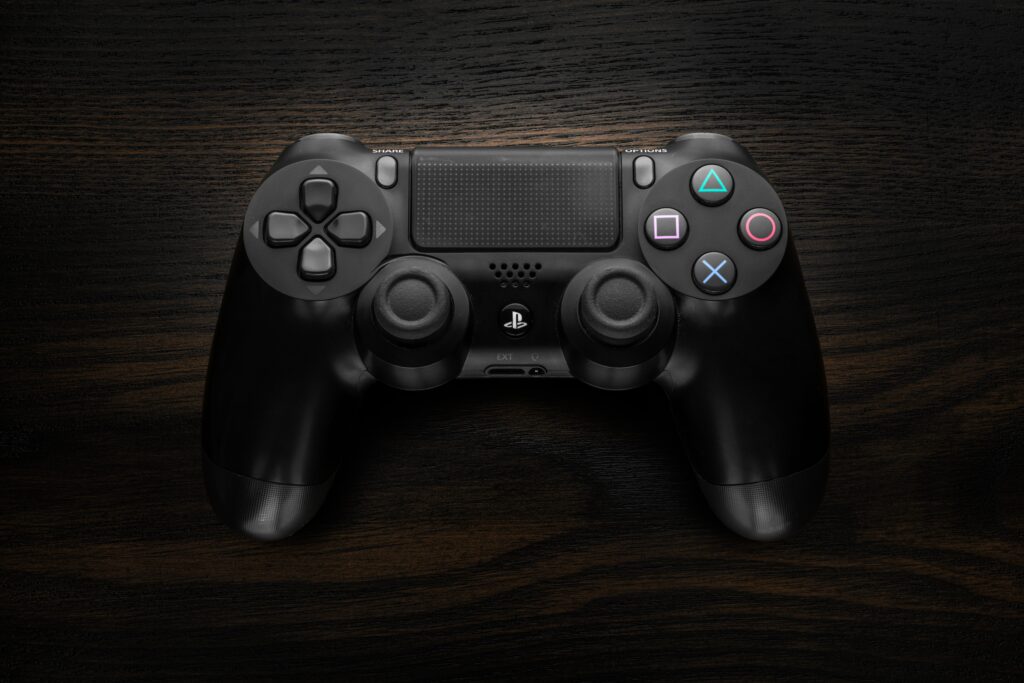 black ps4 controller against black background