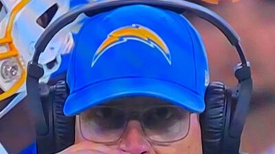 Jim Harbaugh wearing Chargers hat