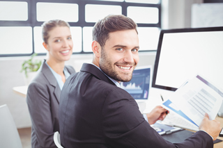 Business professionals in office setting with computers.