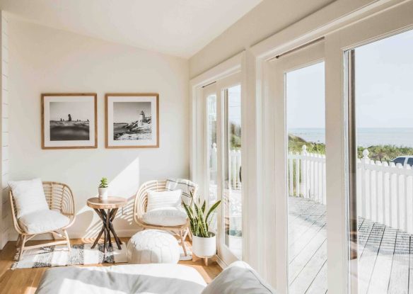 living room facing the ocean with wall of windows