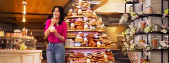 Woman in front of dessert tower