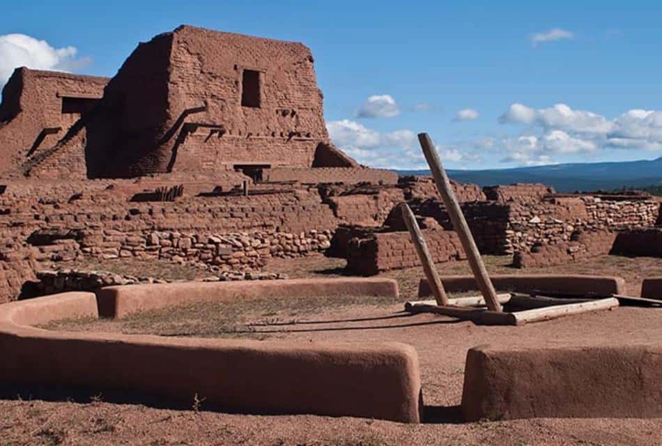 Large adobe building fronted with adobe brick walls.