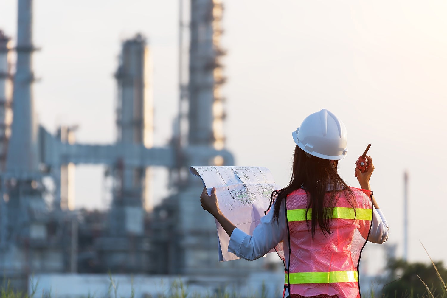 A civil engineer looking at blueprints of a project.