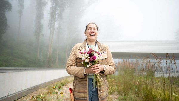 Dunja Duranovic smiles holding bouquet of freshly picked flowers.