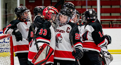 Women's Hockey team celebrates after a goal