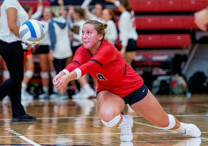 Volleyball student athlete dives to save the ball