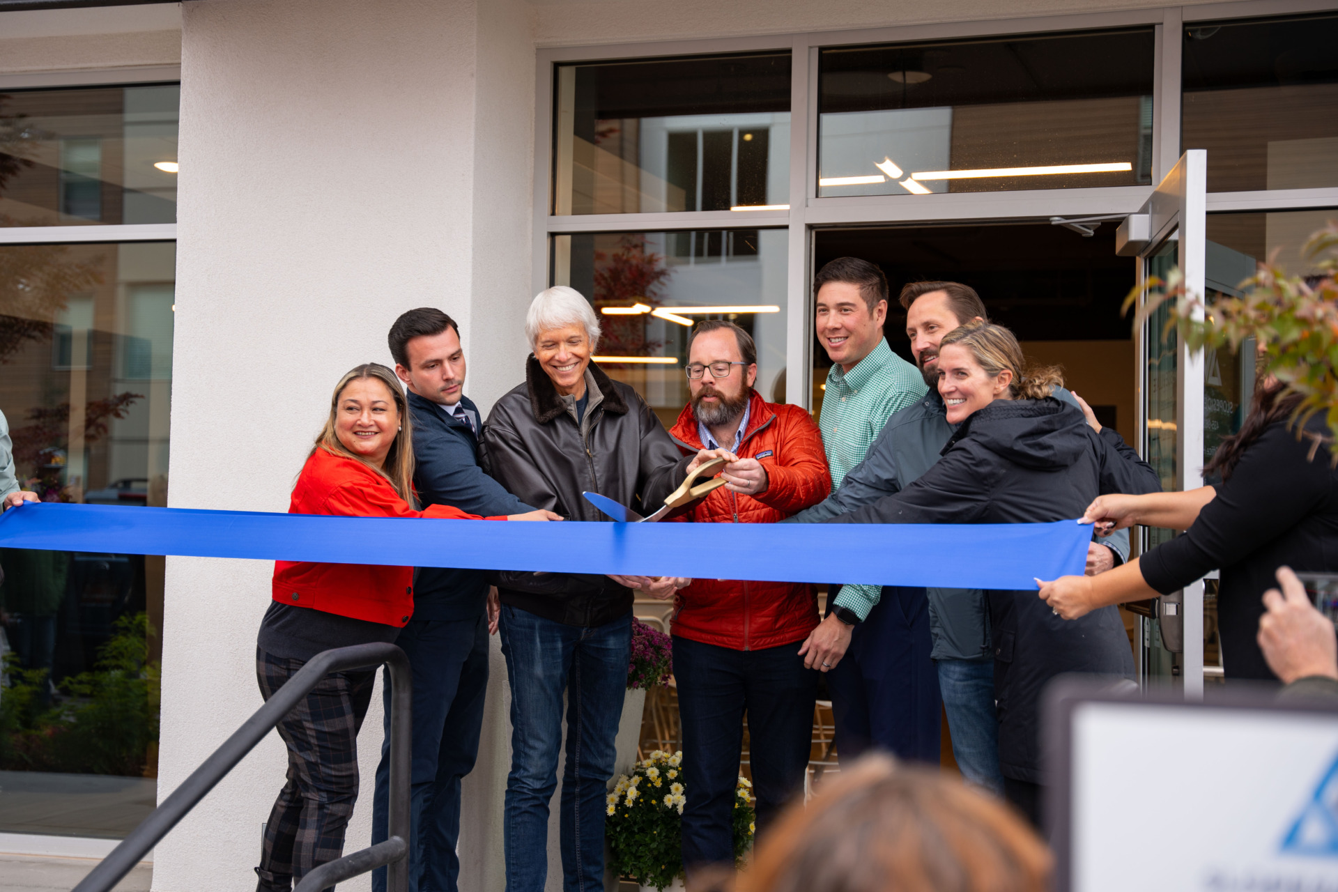 Group of leaders at the ribbon cutting ceremony of the new employee housing location