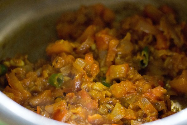 onion, tomato masala being sautéed in cooker