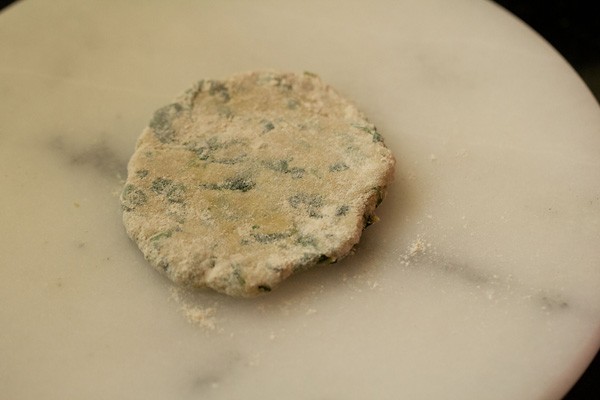 rolled methi paratha dough on a board