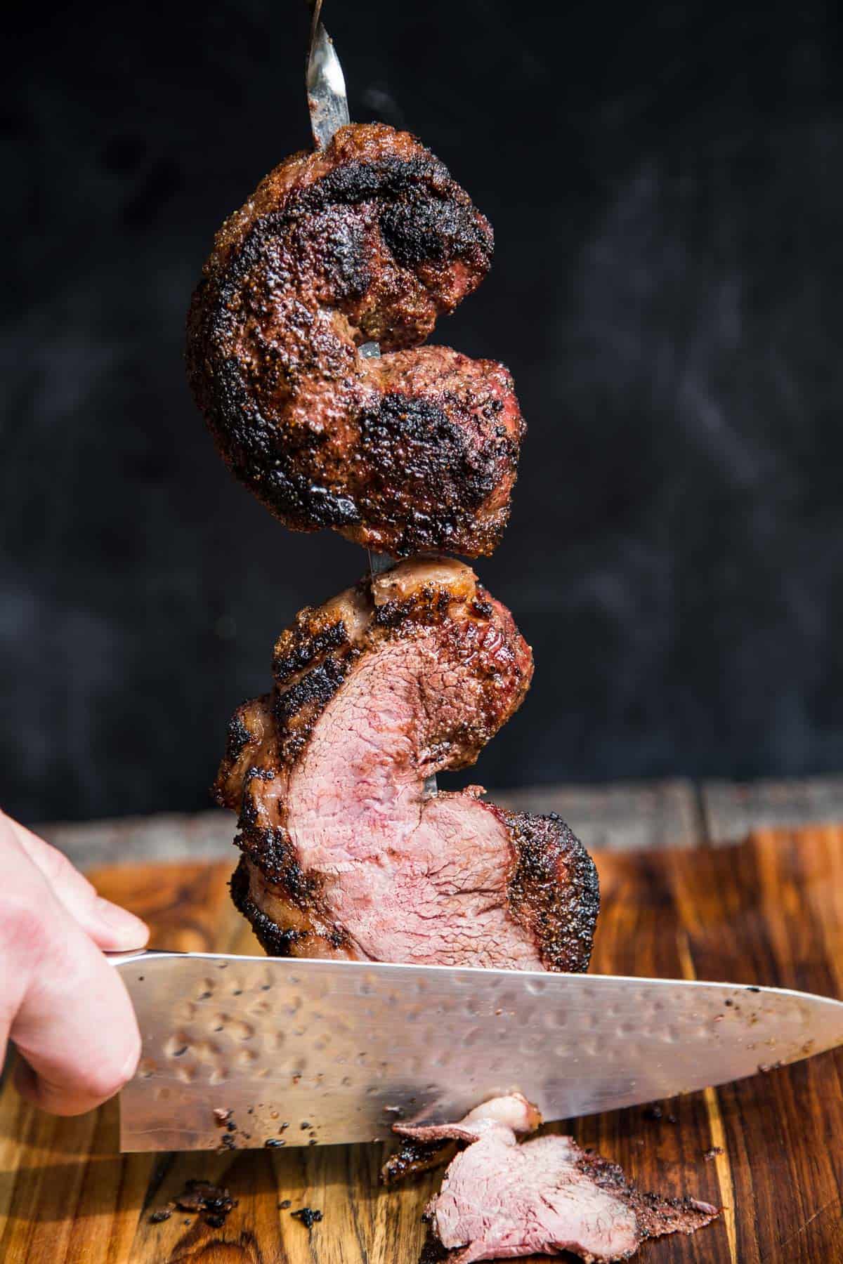 Slicing a Grilled Picanha steak into thin slices