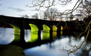 Arch bridge, river, lights, trees, sunset evening wallpaper thumb