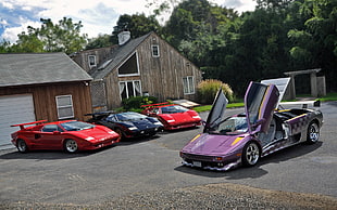 four assorted-color and brand coupe parked near houses