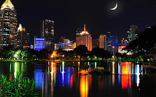 concrete structures near body of water during nightime