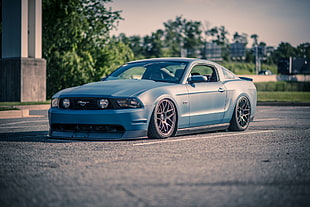 silver Ford Mustang coupe on road