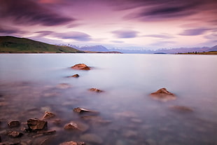 body of water under cloudy blue sky during daytime