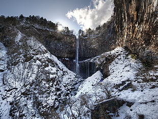 water falls under cloudy blue sky