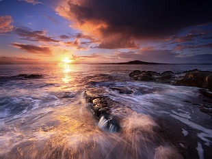 rock formation on seashore during golden hour