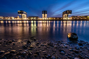 reflective photography of cityscape near body of water