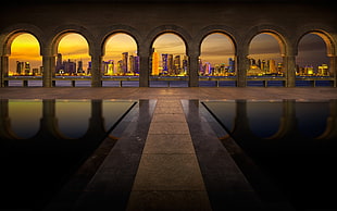 beige concrete post, Qatar, cityscape, arch, skyscraper