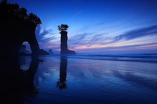 blue body of water under blue and orange sky during sunset