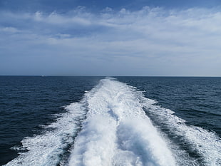 landscape photography of sea under nimbus clouds